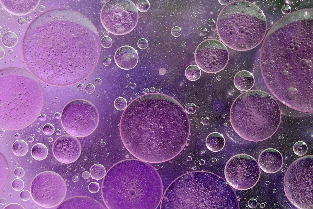 team-03 Purple bubbles creating a vibrant abstract pattern in a liquid background.